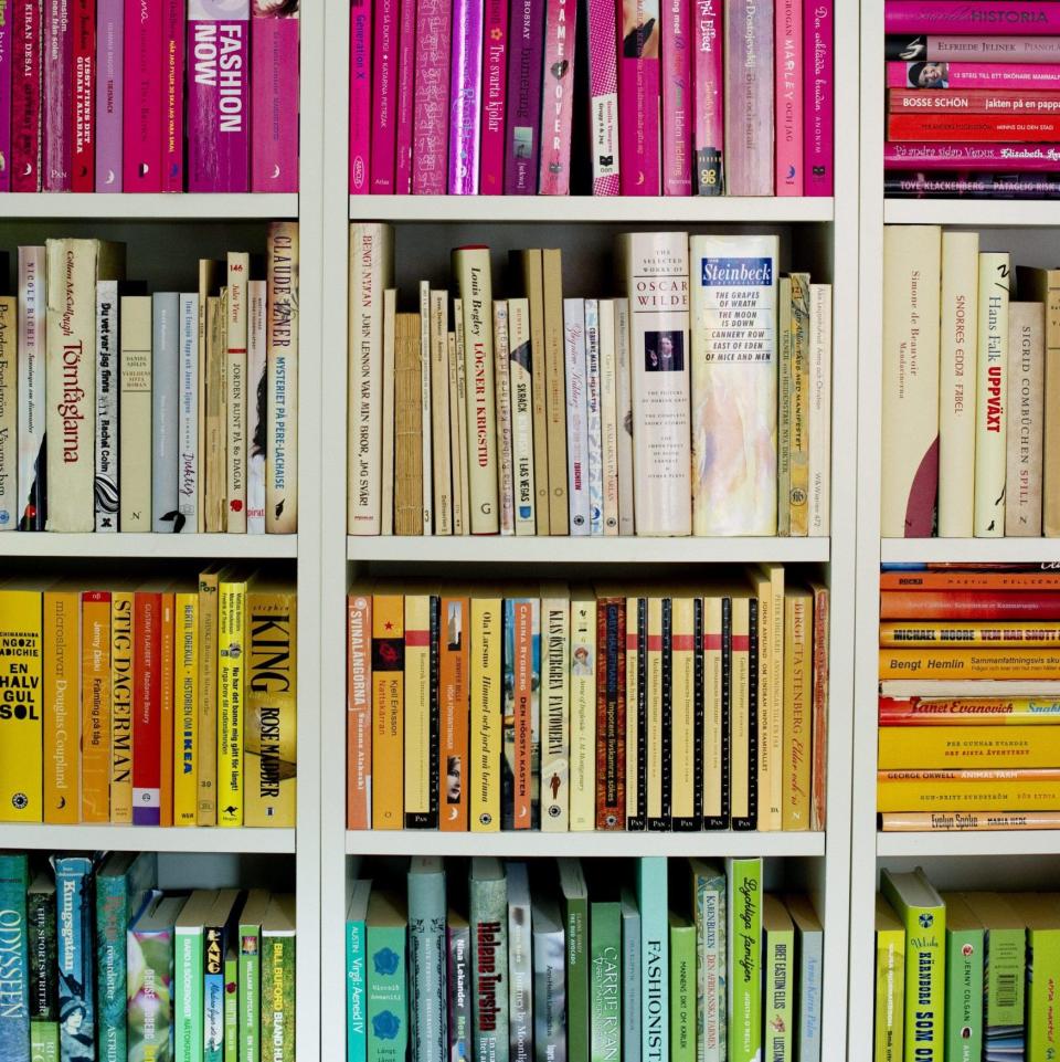 Books arranged by colour implies 'you never look at the actual books', says one interior designer