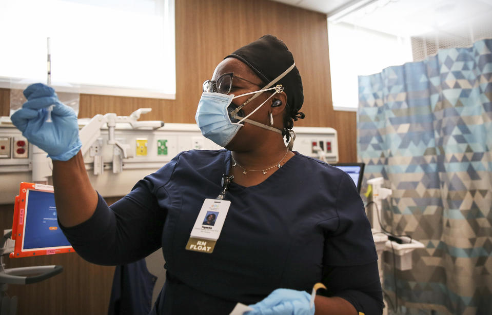 LOS ANGELES, CALIFORNIA - FEBRUARY 25: Travel nurse Tiquella Russell of Texas prepares to administer a dose of the COVID-19 vaccine at a clinic at Martin Luther King Jr. Community Hospital in South Los Angeles on February 25, 2021 in Los Angeles, California. African Americans and Latinos comprise a majority of the South LA community and are dying of COVID-19 at a rate significantly higher than whites. Vaccine equity has also lagged in South Los Angeles relative to some more wealthy areas. (Photo by Mario Tama/Getty Images)