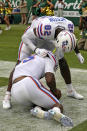 Florida quarterback Anthony Richardson is helped by wide receiver Ja'Markis Weston (82) after Richardson was injureed on an 80-yard touchdown run against South Florida during the second half of an NCAA college football game Saturday, Sept. 11, 2021, in Tampa, Fla. (AP Photo/Chris O'Meara)