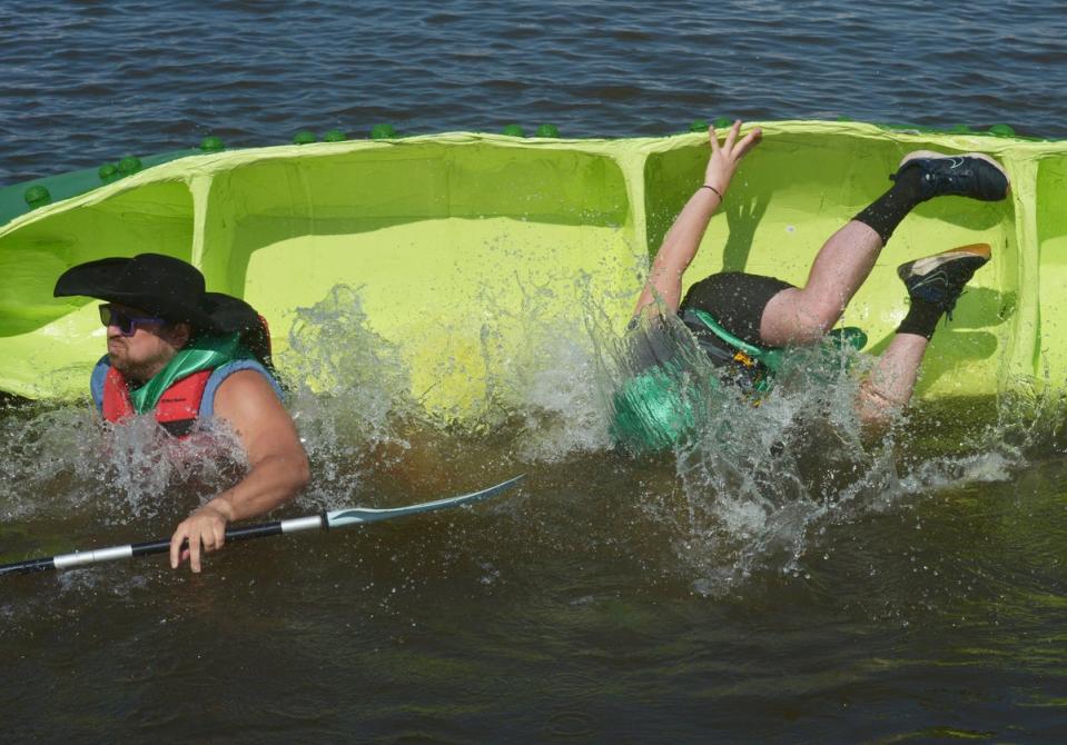 Kyle Brown and Alex Meilstrup, with Honor Credit Union, dump during the start of the first heat, Thursday, July 11, 2024, during the United Way of Southwest Michigan Rock The Boat Cardboard boat races held at The Inn at Harbor Shores in St. Joseph, Michigan (AP)