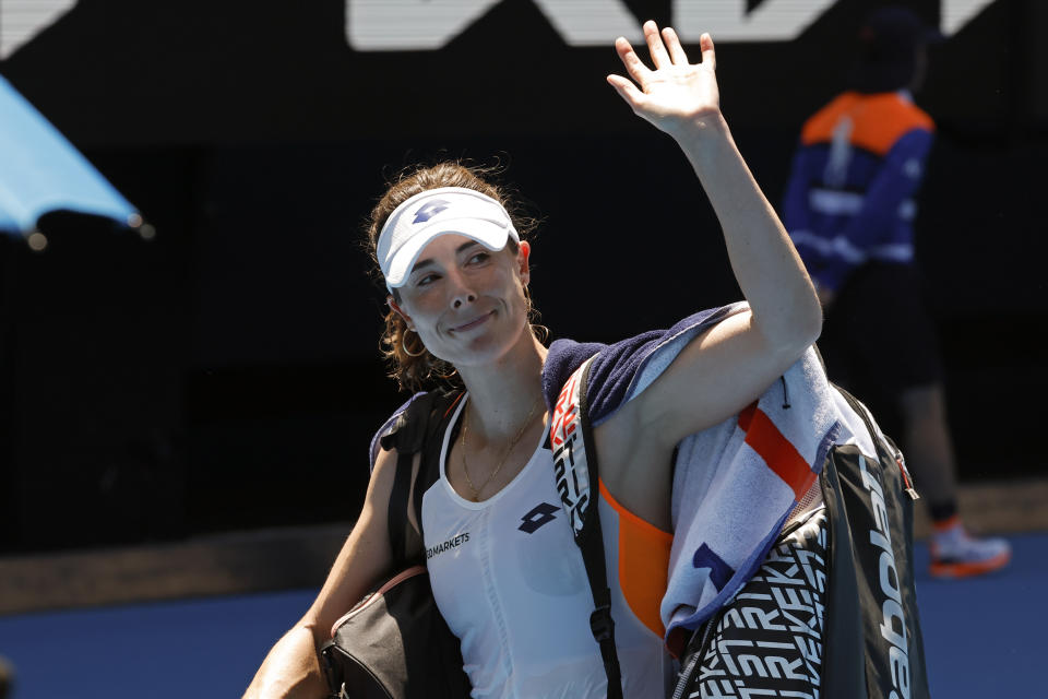 Alize Cornet of France wavs as she leaves Rod Laver Arena following her quarterfinal loss to Danielle Collins of the U.S. at the Australian Open tennis championships in Melbourne, Australia, Wednesday, Jan. 26, 2022. (AP Photo/Hamish Blair)