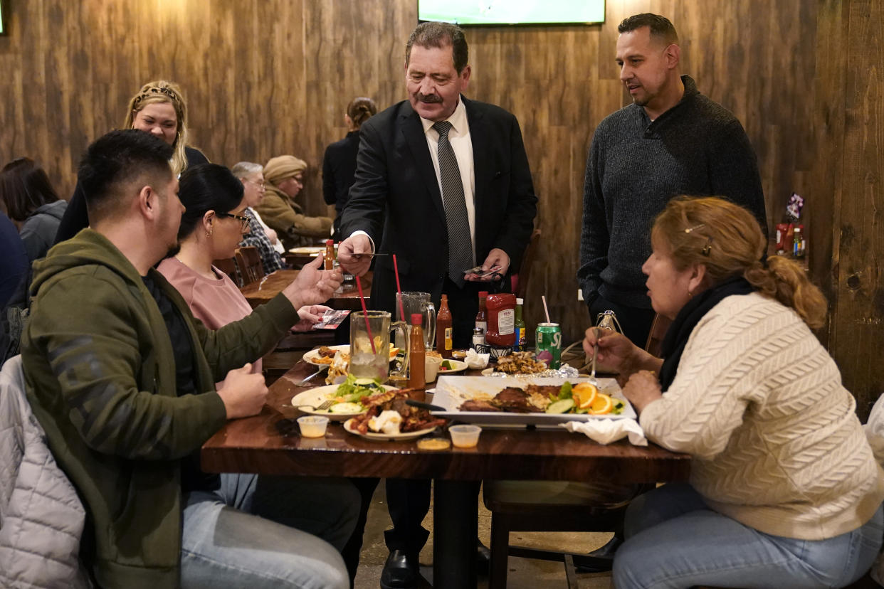 Chicago mayoral candidate Rep., Jesus "Chuy" Garcia, D-Ill., center, campaigns with Chicago Alderman Felix Cardona, right, at the La Costa restaurant Wednesday, Feb. 22, 2023, in Chicago. Garcia, who continues to seek the mayor's office, forced then-Mayor Rahm Emanuel to a runoff in 2015. (AP Photo/Charles Rex Arbogast)