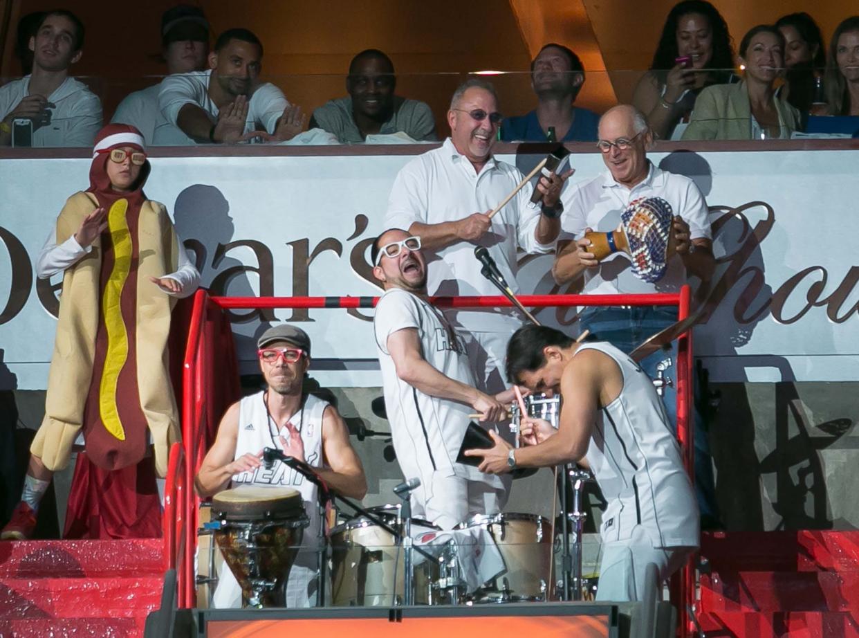 Emilio Estefan (top center) and Jimmy Buffett (top right) join in with the Miami Heat Rhythm Section  during a timeout in game 1 against the Spurs at AmericanAirlines Arena on June 6, 2013. 