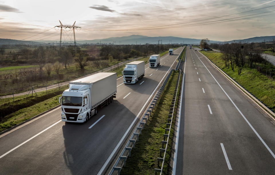 A truck caravan on the highway.