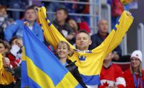 Swedish fans cheer ahead of the men's ice hockey gold medal game against Canada at the 2014 Sochi Winter Olympic Games, February 23, 2014. REUTERS/Laszlo Balogh (RUSSIA - Tags: OLYMPICS SPORT ICE HOCKEY)