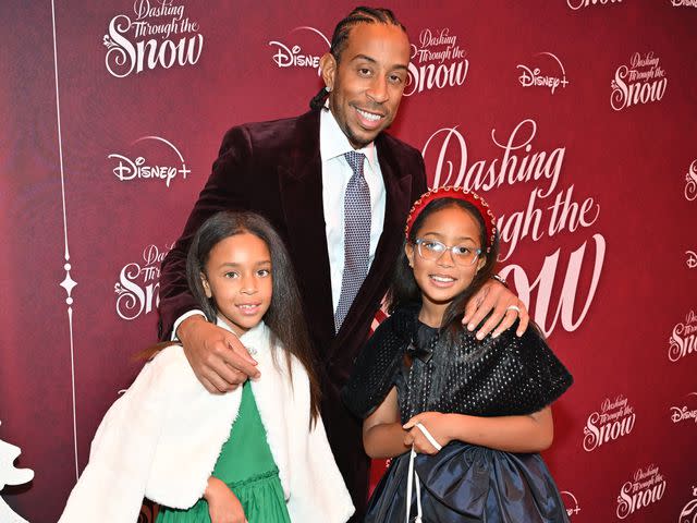 <p>Derek White/Getty</p> Left to right: Cadence Bridges, Ludacris and Cai Bridges attend an Atlanta special screening of Disney's "Dashing Through the Snow" on November 13, 2023 in Atlanta, Georgia.