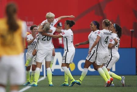 Jun 8, 2015; Winnipeg, Manitoba, CAN; United States midfielder Megan Rapinoe (15) celebrates scoring against Australia with forward Abby Wambach (20) and Megan Klingenberg defender (22) and midfielder Carli Lloyd (10) in a Group D soccer match in the 2015 women's World Cup at Winnipeg Stadium. USA TODAY Sports Images