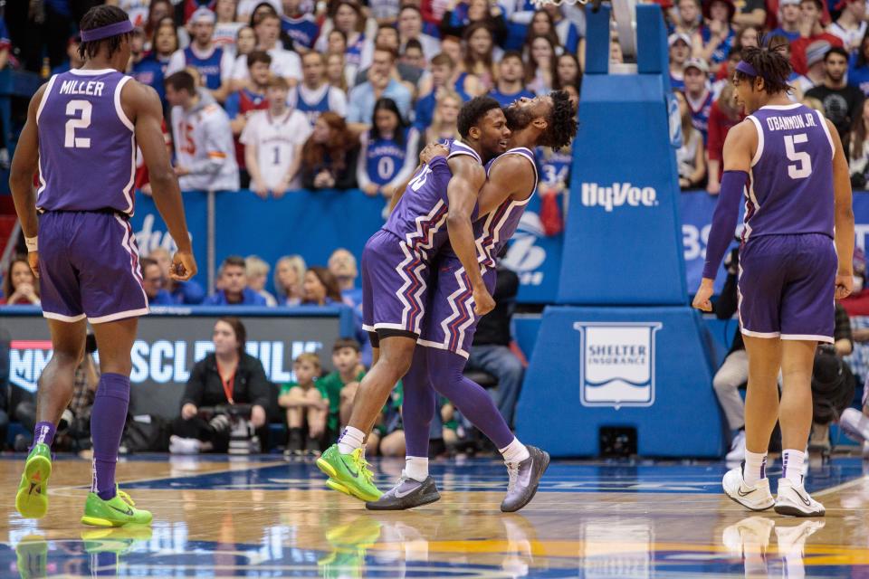 TCU guard Mike Miles Jr. (1) hugs T guard Shahada Wells (13) in reaction to a play during the second half of their defeat of Kansas at Allen Fieldhouse.