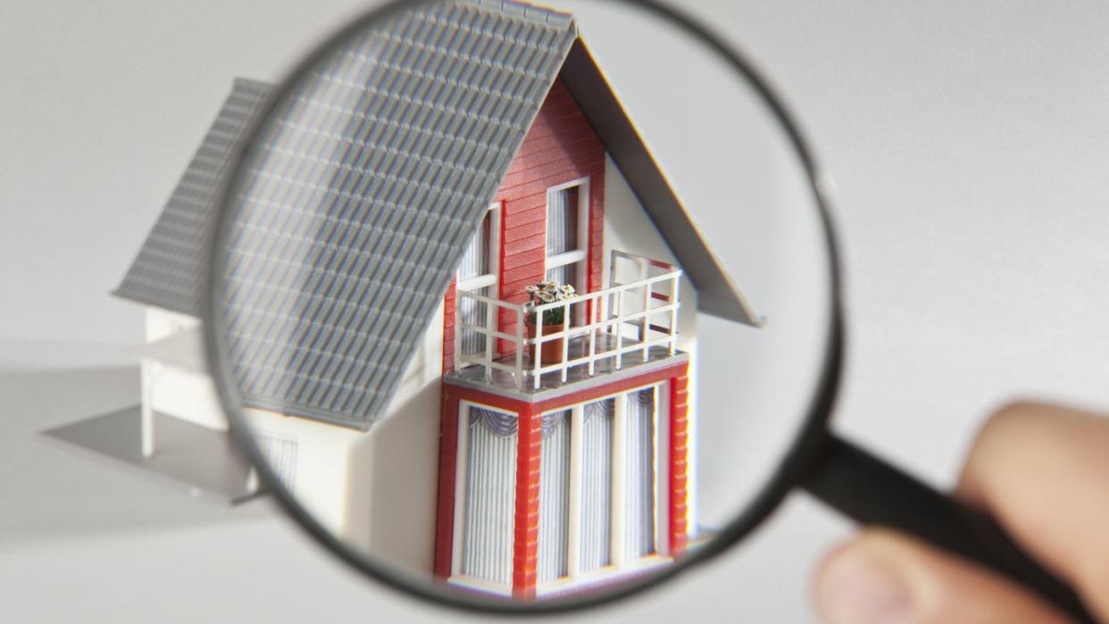 a model house viewed through a magnifying glass