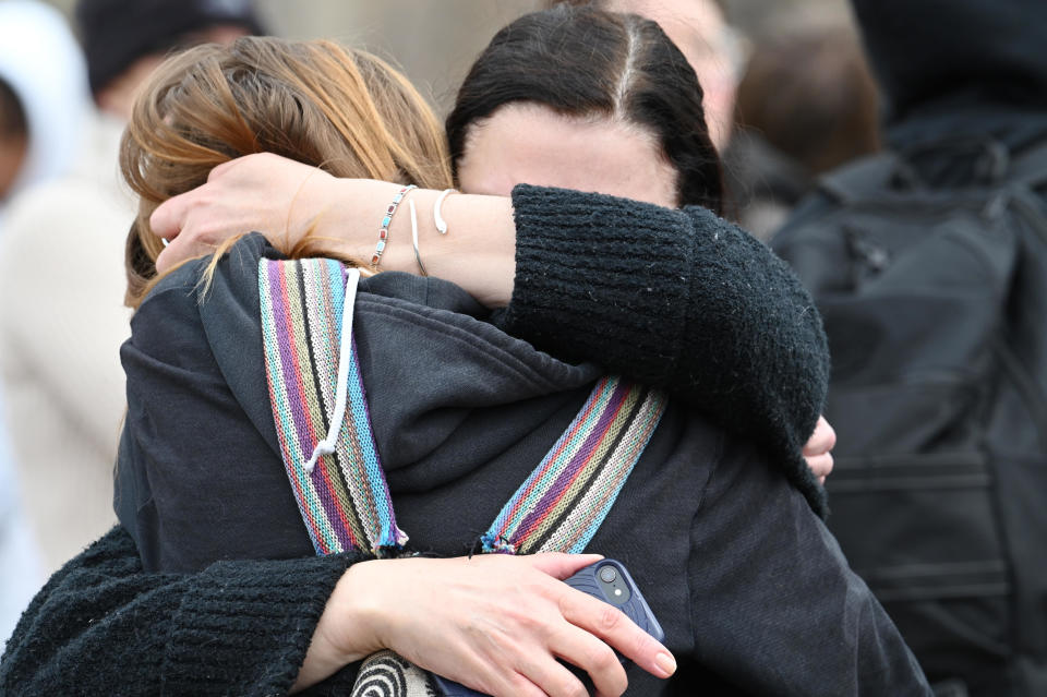 Student is embraced by her mother as they leave Denver's East High School after a shooting there on March 22, 2023. Police said a student shot two adult male faculty members. / Credit: Hyoung Chang / The Denver Post