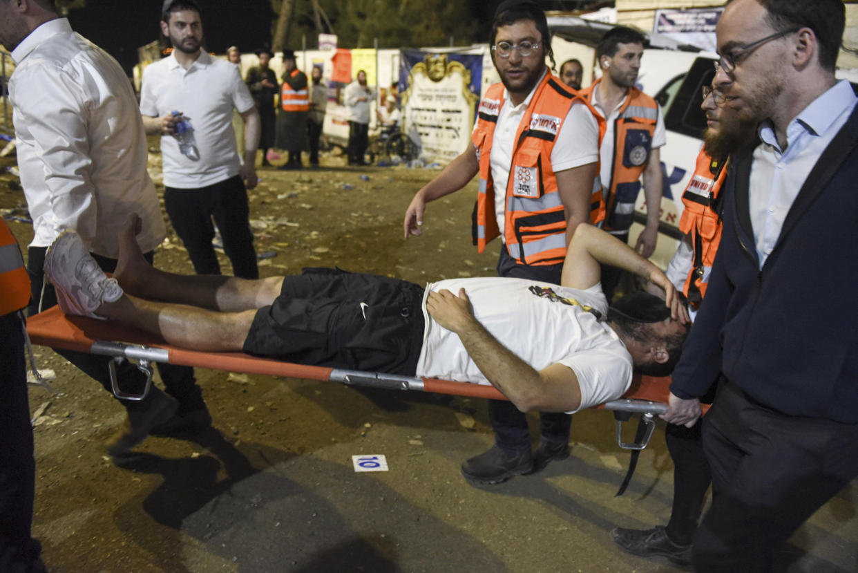 Israeli security officials and rescuers carry an Ultra-Orthodox Jewish man who was injured during the festival of Lag Ba'omer at Mt. Meron in northern Israel, Friday, April 30, 2021. A stampede at a religious festival attended by tens of thousands of ultra-Orthodox Jews in northern Israel killed dozens of people and injured more than 100 others early Friday, medical officials said, in one of the country's deadliest civilian disasters. (AP Photo)