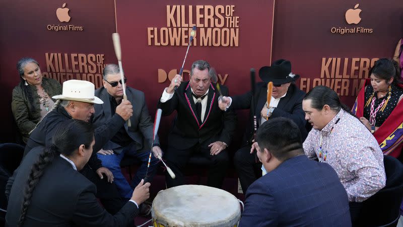 Osage Nation singers perform a traditional song around a drum on the red carpet at the Los Angeles premiere of the film “Killers of the Flower Moon,” on Monday, Oct. 16, 2023, at the Dolby Theater.