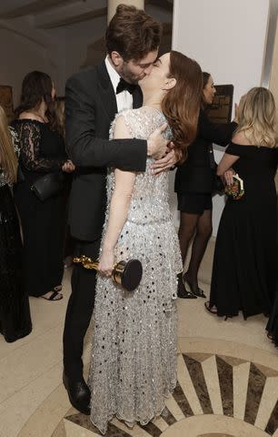 <p>Todd Williamson/January Images/Shutterstock</p> Dave McCary kisses Emma Stone during the Searchlight Pictures Oscar Party at Dante in Los Angeles on March 10, 2024