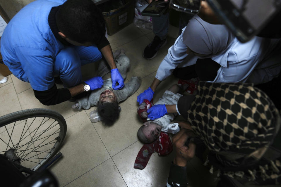 Palestinians wounded in the Israeli bombardment of the Gaza Strip are brought to the hospital in Deir al Balah, Gaza Strip, on Saturday, Dec. 23, 2023. (AP Photo/Adel Hana)