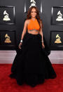 <p>She was a little late…but man, wasn’t it worth it? RiRi stepped out in an Armani Privé orange-toned crop top embroidered in crystals—it expertly drew all eyes to her under-boob tattoo. She complemented it with a full black voluminous silk organza skirt and luxury jewelry by Chopard. Slay, Ri! </p>