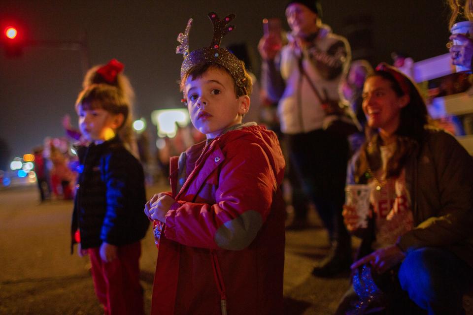 James Rodriguez and Crosby McBroom watch the Columbia Main Street Christmas Parade in Columbia, Tenn., on Saturday, Dec. 4, 2021.