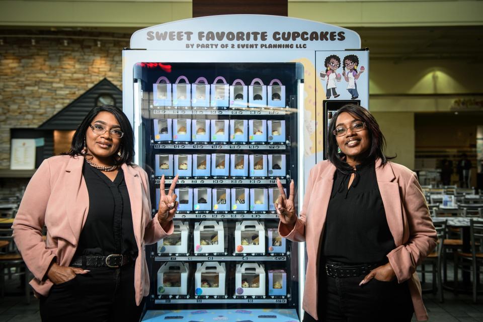 Melissa Moore and Melinda Borom sell their cupcakes in a vending machine at the Cross Creek Mall.