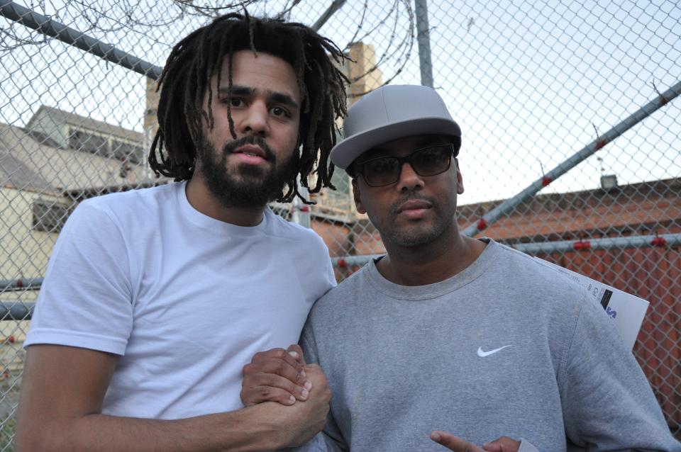 This undated image shows music artist J Cole, left, with incarcerated Swedish music producer David Jassy at San Quentin State Prison in California. Jassy, whose sentence was commuted by California Gov. Gavin Newsom this year, produced an album “San Quentin Mixtape, Vol. 1," featuring work from 17 incarcerated rappers. (David Jassy via AP)