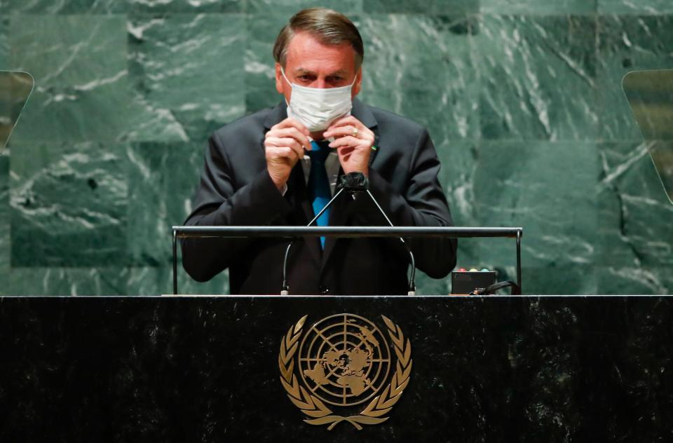 File: Brazil’s president Jair Bolsonaro puts on a protective face mask after speaking at the 76th Session of the UN General Assembly in New York on 21 September 2021 (ASSOCIATED PRESS)