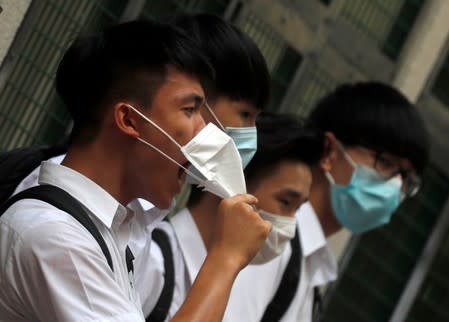 A secondary school student shouts slogans as he joins a human chain demonstrating against what the students say is police brutality against protesters, after clashes at Wan Chai district in Hong Kong