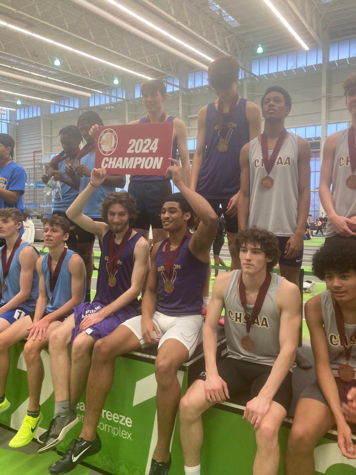 The 2024 Section V indoor track distance medley relay on the podium at the state meet on Staten Island.