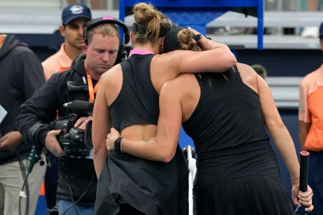 Aryna Sabalenka, right, and Paula Badosa walk off court together after their match