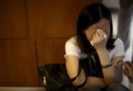 A family member of passengers on the ship which sank at the Jianli section of Yangtze River, in Hubei province, cries outside a closed office of Xiehe Travel in Shanghai, China, June 2, 2015. REUTERS/Stringer