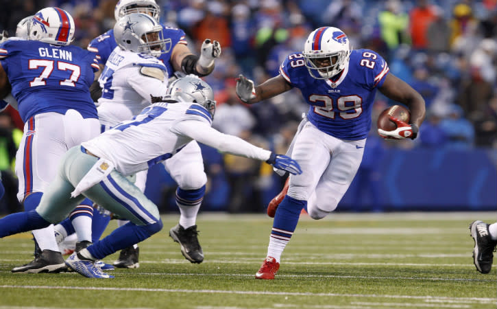 Dec 27, 2015; Orchard Park, NY, USA; Buffalo Bills running back Karlos Williams (29) rushes wit the football against Dallas Cowboys free safety J.J. Wilcox (27) during the second half at Ralph Wilson Stadium. Buffalo beats Dallas 16 to 6. Mandatory Credit: Timothy T. Ludwig-USA TODAY Sports
