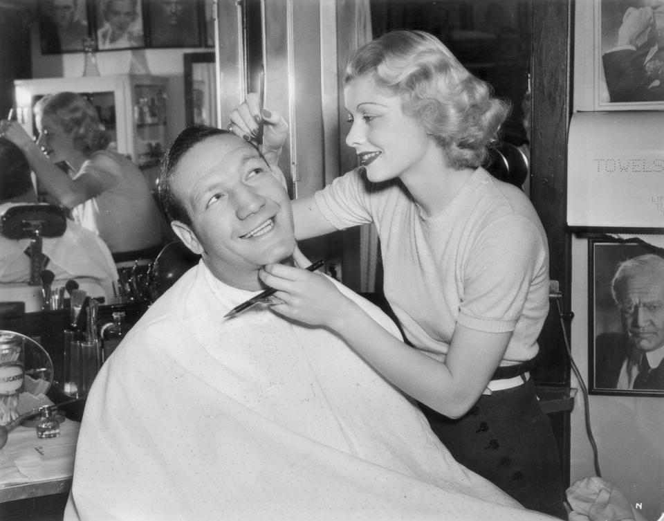 1936: Drawing brow makeup on boxer Maxie Rosenbloom on the set of "Muss 'Em Up."