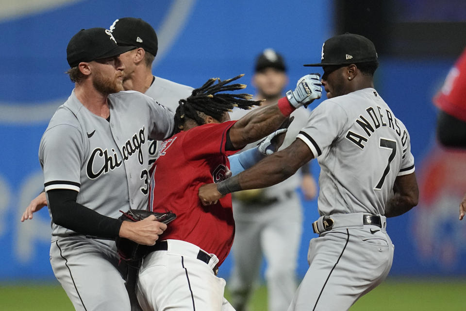 Cleveland Guardians' Jose Ramirez, center, and Chicago White Sox's Tim Anderson (7) exchange punches in the sixth inning of a baseball game Saturday, Aug. 5, 2023, in Cleveland. White Sox's Michael Kopech, left looks on. (AP Photo/Sue Ogrocki)