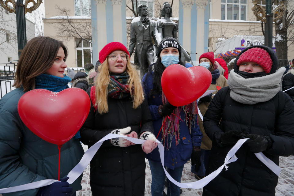 Women, some of them wearing face masks to protect against coronavirus, attend a rally in support of jailed opposition leader Alexei Navalny and his wife Yulia Navalnaya, in Moscow, Russia, Sunday, Feb. 14, 2021. Participants formed a human chain in a show of solidarity with those who were detained during protests calling for the release of jailed Russian opposition leader Alexei Navalny, and the Kremlin has accused the West of meddling in Russia's affairs by denouncing the crackdown on protests. (AP Photo/Alexander Zemlianichenko)