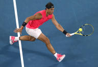 Spain's Rafael Nadal makes a forehand return to Australia's Nick Kyrgios during their fourth round singles match at the Australian Open tennis championship in Melbourne, Australia, Monday, Jan. 27, 2020. (AP Photo/Andy Wong)