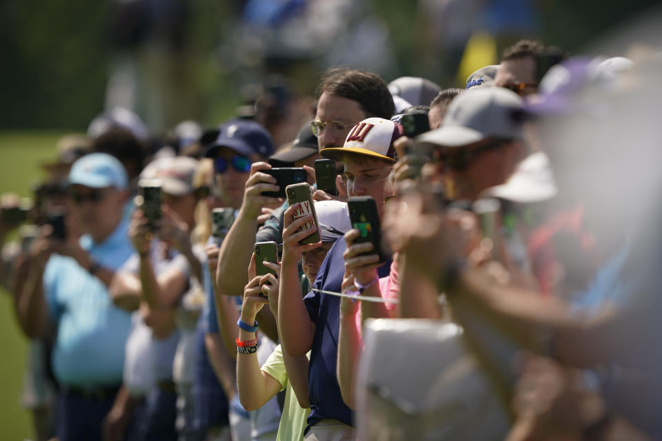 Fans watch on the eighth hole during a practice round for the PGA Championship golf tournament, Wednesday, May 18, 2022, in Tulsa, Okla. (AP Photo/Matt York)