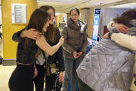 Larysa Haivoronska, left, hugs Yevangelina Tkalento as Oleksandra Mudrak, center, looks on at a New York hotel, April 8, 2022, after spending nearly a week together taking part in the National Model United Nations Conference. The Ukrainian college students have been torn about returning to their war-torn homeland. (AP Photo/Bobby Caina Calvan)
