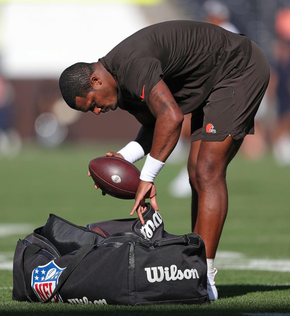 Cleveland Browns quarterback Deshaun Watson checks the balls before an NFL preseason football game against the Chicago Bears, Saturday, Aug. 27, 2022, in Cleveland, Ohio.