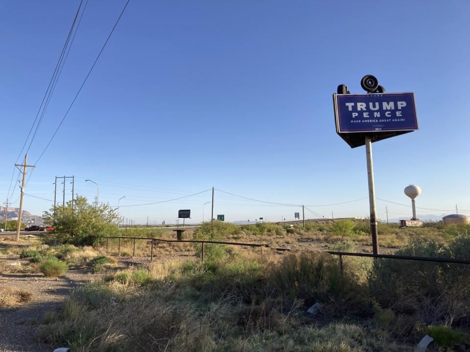 A campaign billboard from the 2020 election looms over the desert outside Alamogordo, N.M., on Wednesday, May 12, 2021. The election defeat of Donald Trump and the arrest of a local county commissioner in connection with the Jan. 6 Capitol riots have jolted the politically conservative region. County Commissioner and Cowboys for Trump Founder Couy Griffin is contending with federal criminal charges, a recall initiative and state probes into his finances as he fights for his political future. (AP Photo/Morgan Lee)