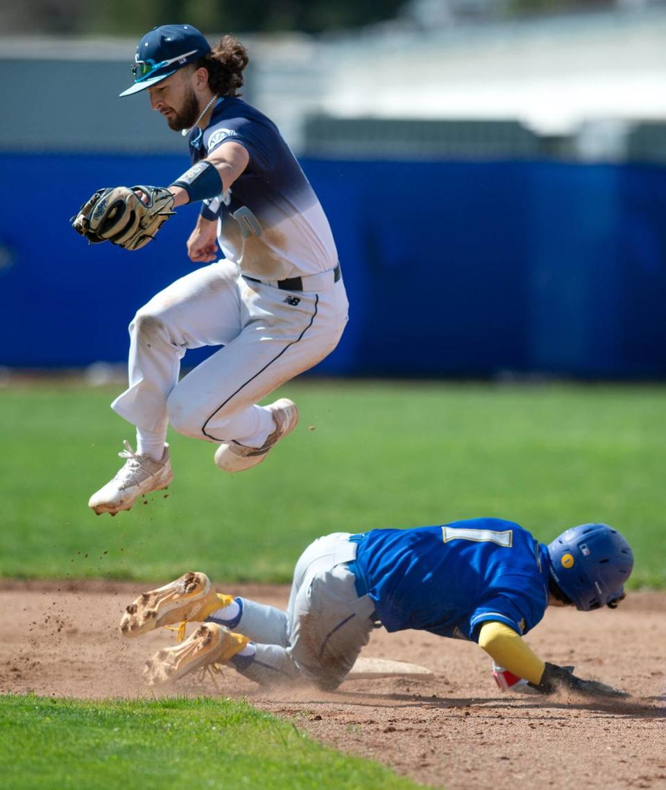 Downey shortstop Camden Rush forces out Turlock runner Josh Ramirez during the Central California Athletic league game at Downey High School in Modesto, Calif., Thursday, March 23, 2023.
