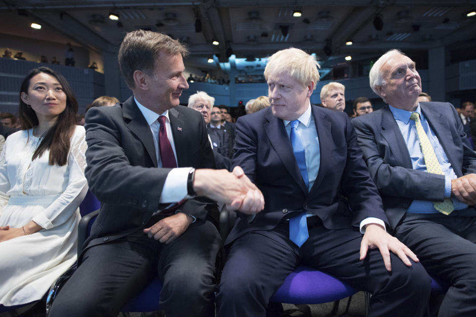 Jeremy Hunt, second left, congratulates Boris Johnson after the announcement of the result in the ballot for the new Conservative party leader, in London, Tuesday, July 23, 2019. Brexit hardliner Boris Johnson won the contest to lead Britain's governing Conservative Party on Tuesday and will become the country's next prime minister, tasked with fulfilling his promise to lead the U.K. out of the European Union "come what may." (Stefan Rousseau/Pool photo via AP)