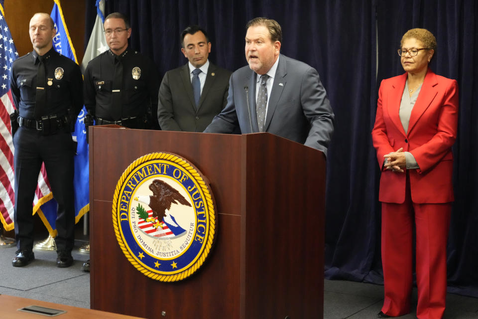 Jeffrey Abrams, Regional Director of Anti-Defamation League, ADL Los Angeles, at podium, denounces anti-Semitism and hate crimes at a news conference at the U.S. Attorney's Office Central District of California offices in Los Angeles Friday, Feb. 17, 2023. From left, United States Attorney Martin Estrada and Los Angeles Mayor Karen Bass. A person was taken into custody Thursday in connection with the shootings of two Jewish men outside synagogues in Los Angeles this week that investigators believe were hate crimes, police said. (AP Photo/Damian Dovarganes)