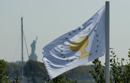 Sep 25, 2017; Jersey City, NJ, USA; A Presidents Cup flag with the Statue of Liberty in the background during The Presidents Cup golf tournament at Liberty National Golf Course. Mandatory Credit: Bill Streicher-USA TODAY Sports