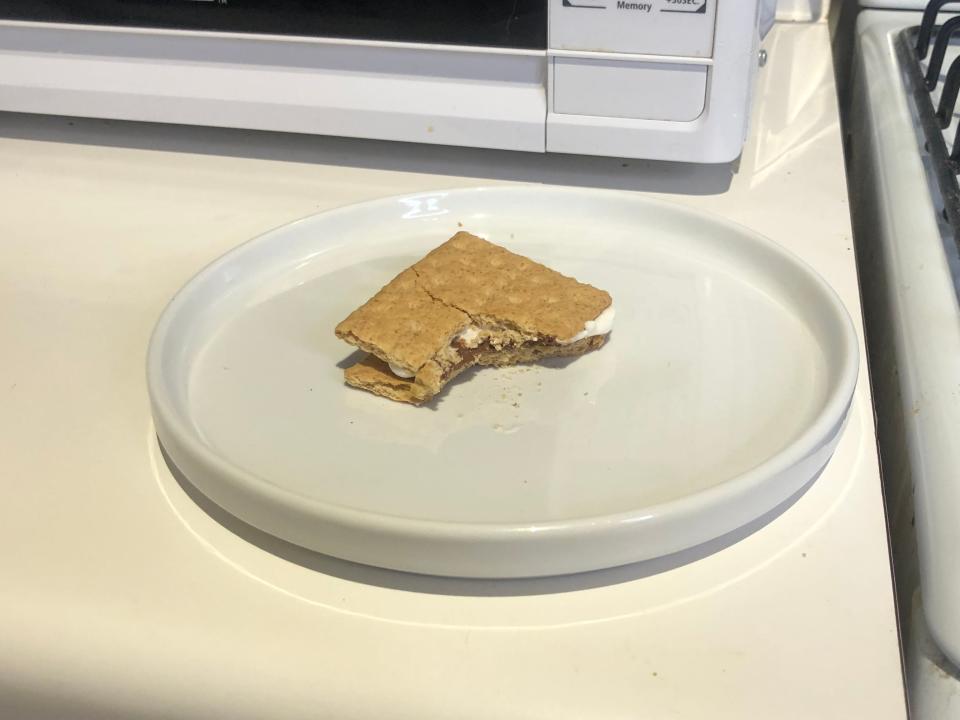 smore sitting on a white plate next to a stove