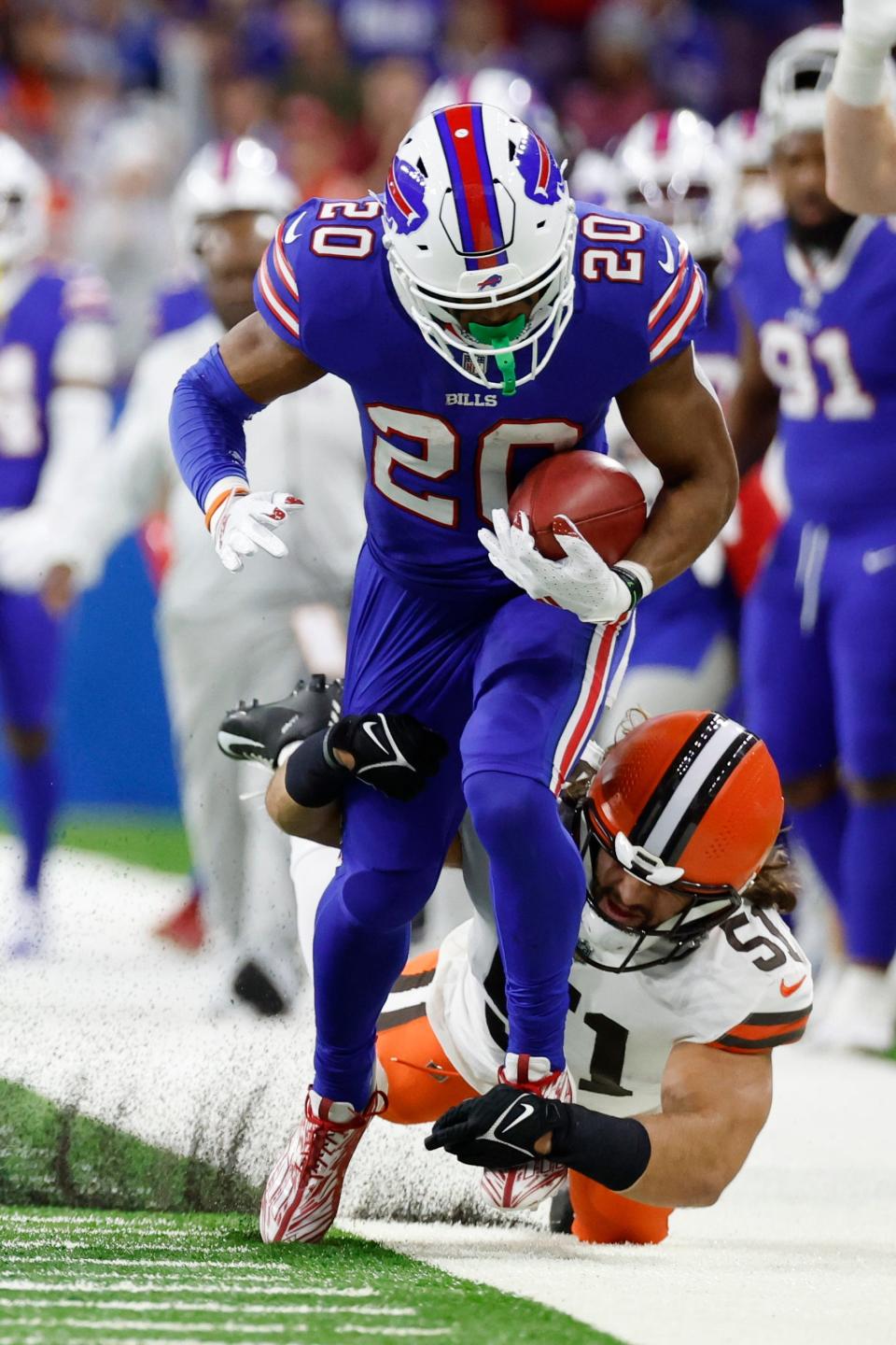 Buffalo Bills running back Nyheim Hines (20) is tackled by Cleveland Browns linebacker Jordan Kunaszyk (51) in the first half during an NFL football game, Sunday, Nov. 20, 2022, in Detroit. (AP Photo/Rick Osentoski)