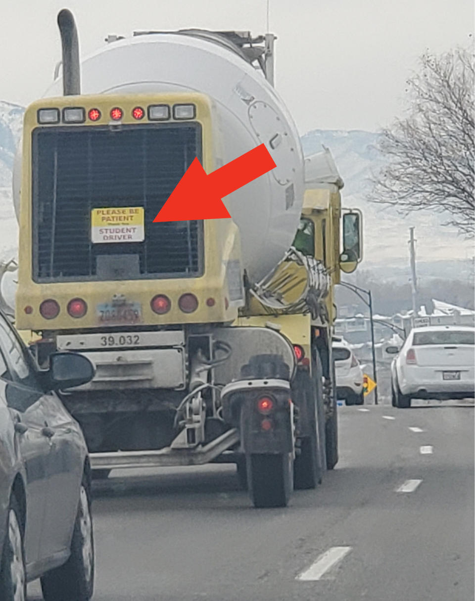 "Please be patient, student driver" sign on the back of a huge truck