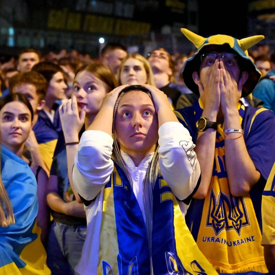 Ukraine’s fans react as they watch on a giant screen the broadcast of the quarter-final football match aganst England.