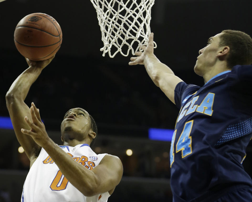 Florida Kasey Hill shoots as UCLA guard Zach LaVine (14) looks on during the first half in a regional semifinal game at the NCAA college basketball tournament, Thursday, March 27, 2014, in Memphis, Tenn. (AP Photo/Mark Humphrey)