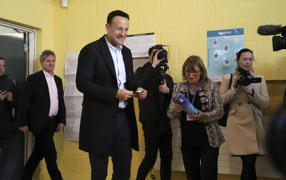 Fine Gael leader Leo Varadkar votes in the Irish General Election at Scoil Thomais in Castleknock, Dublin, Saturday, Feb. 8, 2020. Irish voters are choosing their next prime minister in an election where frustration with economic austerity and a housing crisis have fueled the rise of Sinn Fein, still shunned by the country's main political parties because of its links to the Irish Republican Army. (Damien Storan/PA via AP)