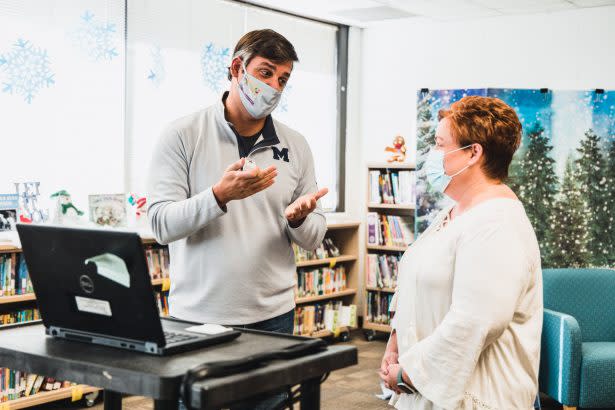 Marietta Superintendent Grant Rivera, left, speaks with a staff member last school year. In early 2021, the district partnered with the CDC to study COVID transmission in classrooms. (Marietta City Schools / Facebook)