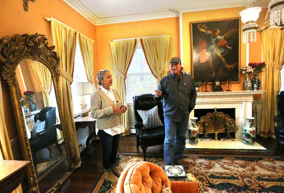 Katie and Hunt Edwards walk through the living room of the Wedding Cake House they own in Kennebunk. The couple has invested much money and time into the historic venue they hope to open as an inn and venue for different events.