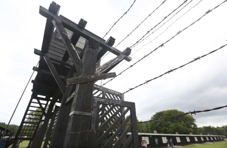 FILE - In this July 18, 2017 file photo, the wooden main gate leads into the former Nazi German Stutthof concentration camp in Sztutowo, Poland. 93-year-old former SS private Bruno Dey is going on trial at the criminal court in Hamburg on 5,230 counts of being an accessory to murder, accused of helping the Nazis' Stutthof concentration camp function. (AP Photo/Czarek Sokolowski, file)