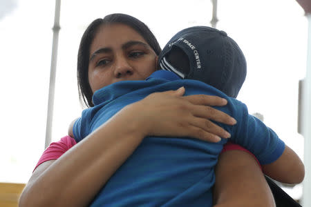 FILE PHOTO: Dunia, an asylum seeker from Honduras, is reunited with her five-year-old son Wilman at Brownsville South Padre International Airport in Brownsville, Texas, U.S., following their separation of more than five weeks through the Trump administration's "Zero Tolerance" policy, July 20, 2018. REUTERS/Loren Elliott/File Photo